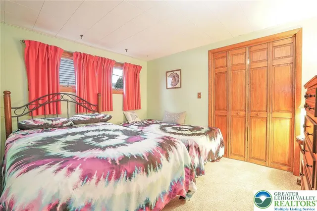 a bathroom with a granite countertop sink and a window