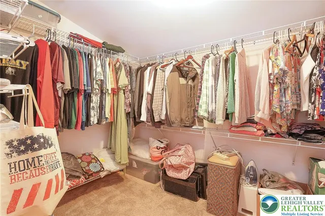 a bedroom with two beds and painting on the wall