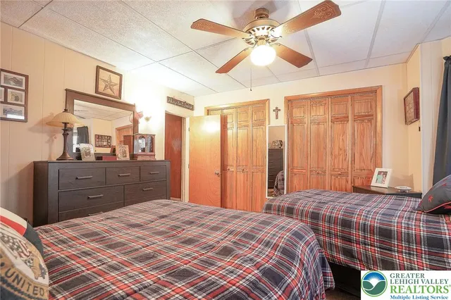 a bedroom with a bed and a wall painting