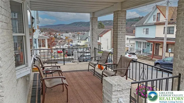a view of balcony with wooden floor and seating space