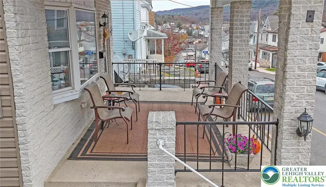 a living room with furniture a window and gym equipment