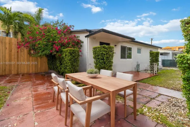a view of a patio with table and chairs and potted plants