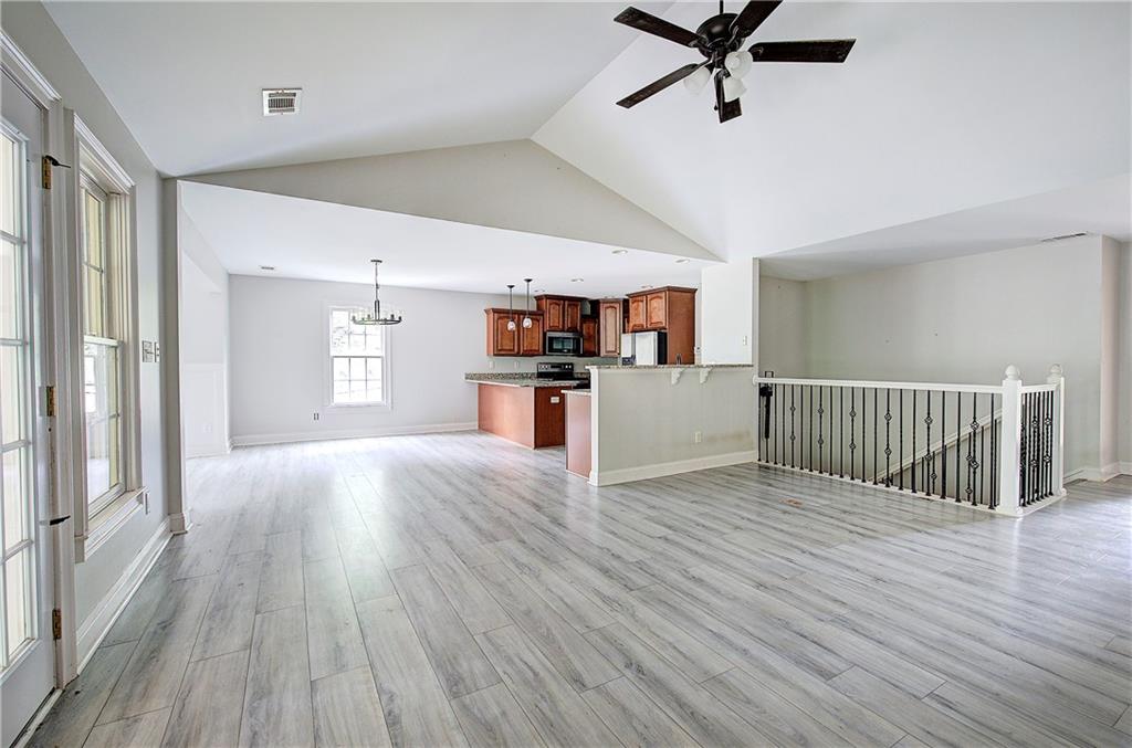 561 Holland Road Dallas, GA 30157 - Photo 7 of 48 a view of a livingroom with a hardwood floor and a ceiling fan
