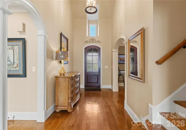 a view of a hallway with entryway wooden floor and front door