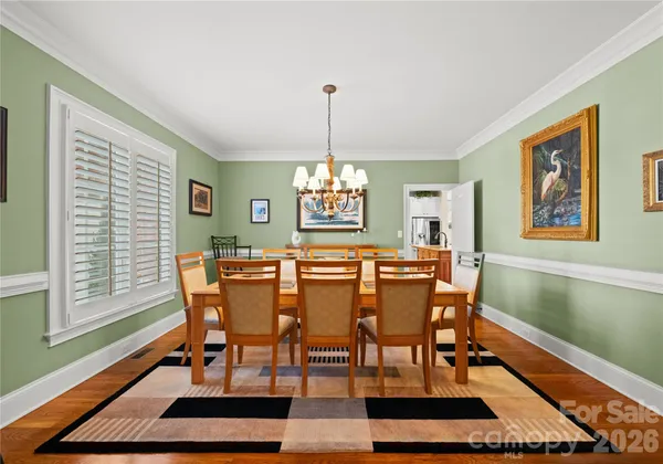 a dining room with furniture a rug and a chandelier