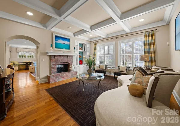 a living room with furniture fireplace and a large window