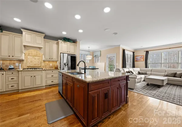 a kitchen with stainless steel appliances granite countertop a stove and a sink