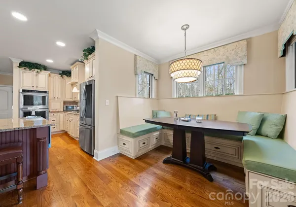 a kitchen that has a lot of cabinets and refrigerator