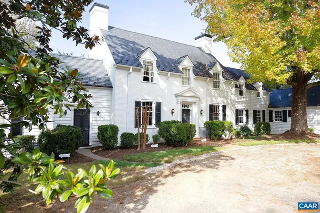 a front view of a residential houses with yard
