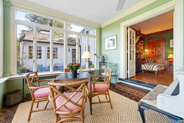 a dining room with furniture and wooden floor