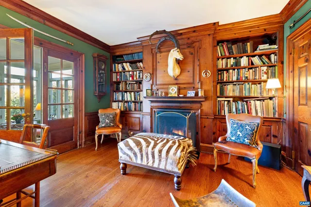 a living room with furniture a rug and a bookshelf