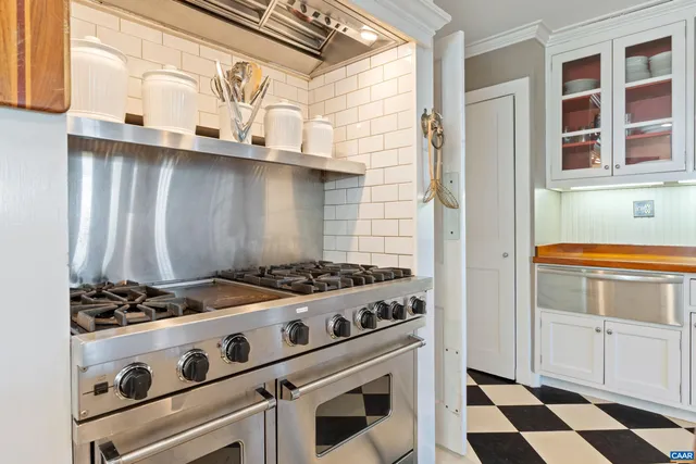 a white stove top oven sitting inside of a kitchen