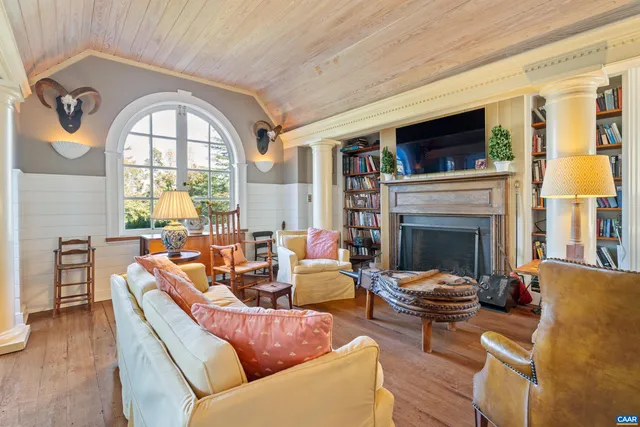 a living room with furniture fireplace and a flat screen tv