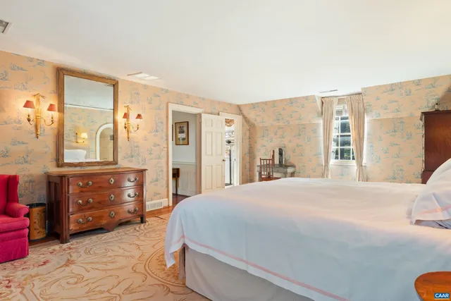 a bedroom with a bed and a dresser