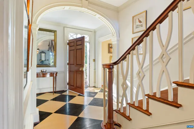 a view of staircase with wooden floor and a rug