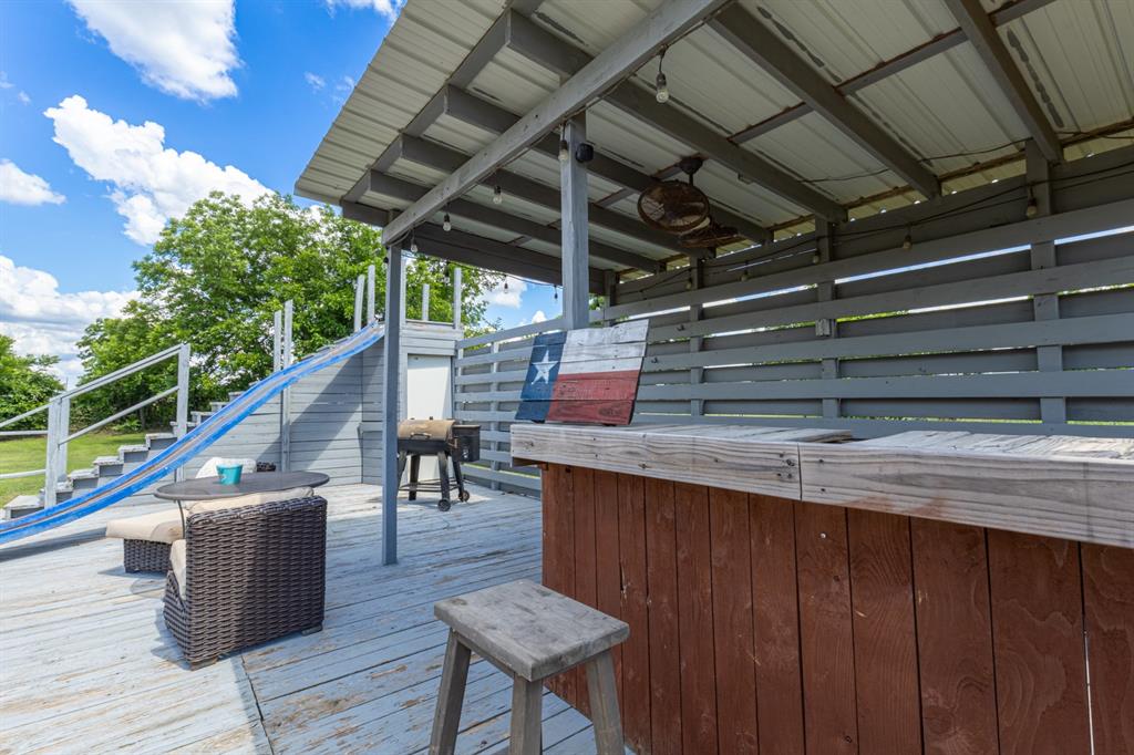 75 Southern Road Mineral Wells, TX 76067 - Photo 28 of 31 a roof deck with wooden floor and fence with wooden floor