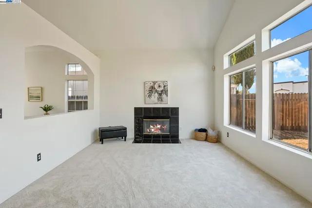 a view of a livingroom with a fireplace and window