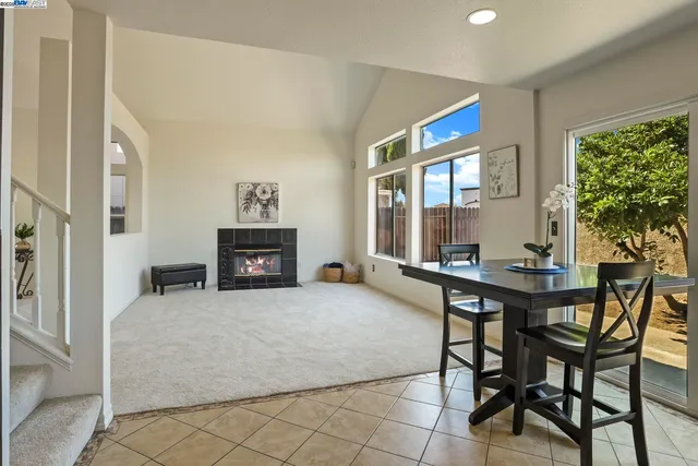 a living room with furniture a fireplace and a large window