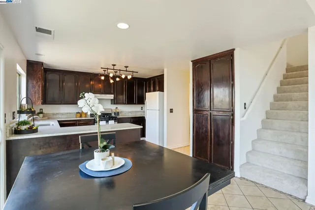 a kitchen with a dining table and chairs