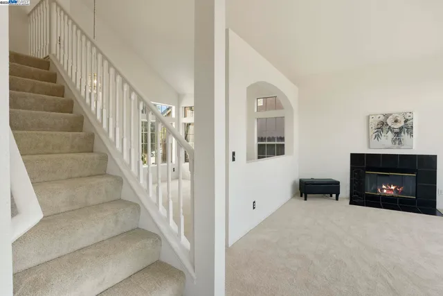 a view of an empty room and fire place