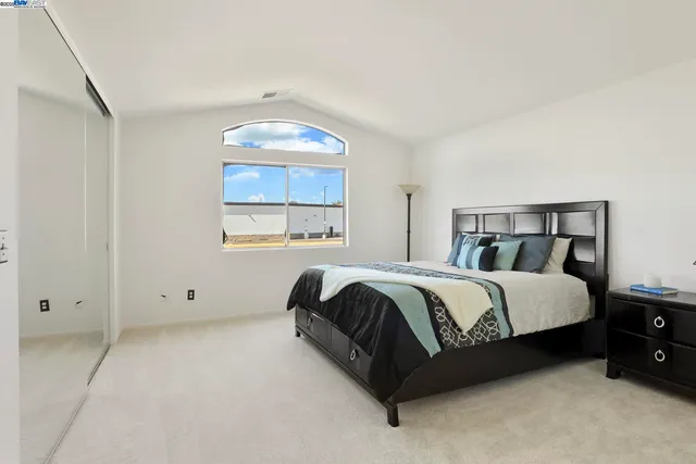 a spacious bedroom with a bed and window