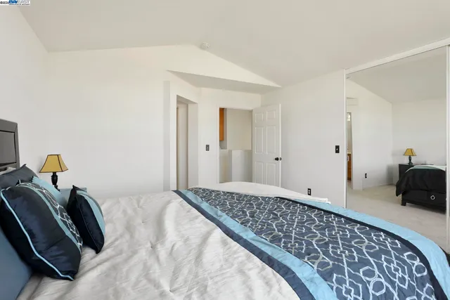 a bedroom with a bed and a couch