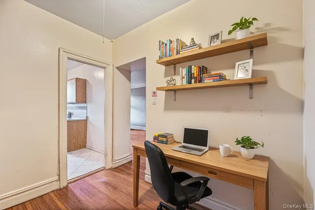a view of a workspace with furniture and wooden floor