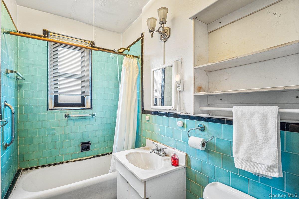 77-16 Austin Street, Unit 5L Queens, NY 11375 - Photo 8 of 13 a bathroom with a sink mirror toilet and bathtub