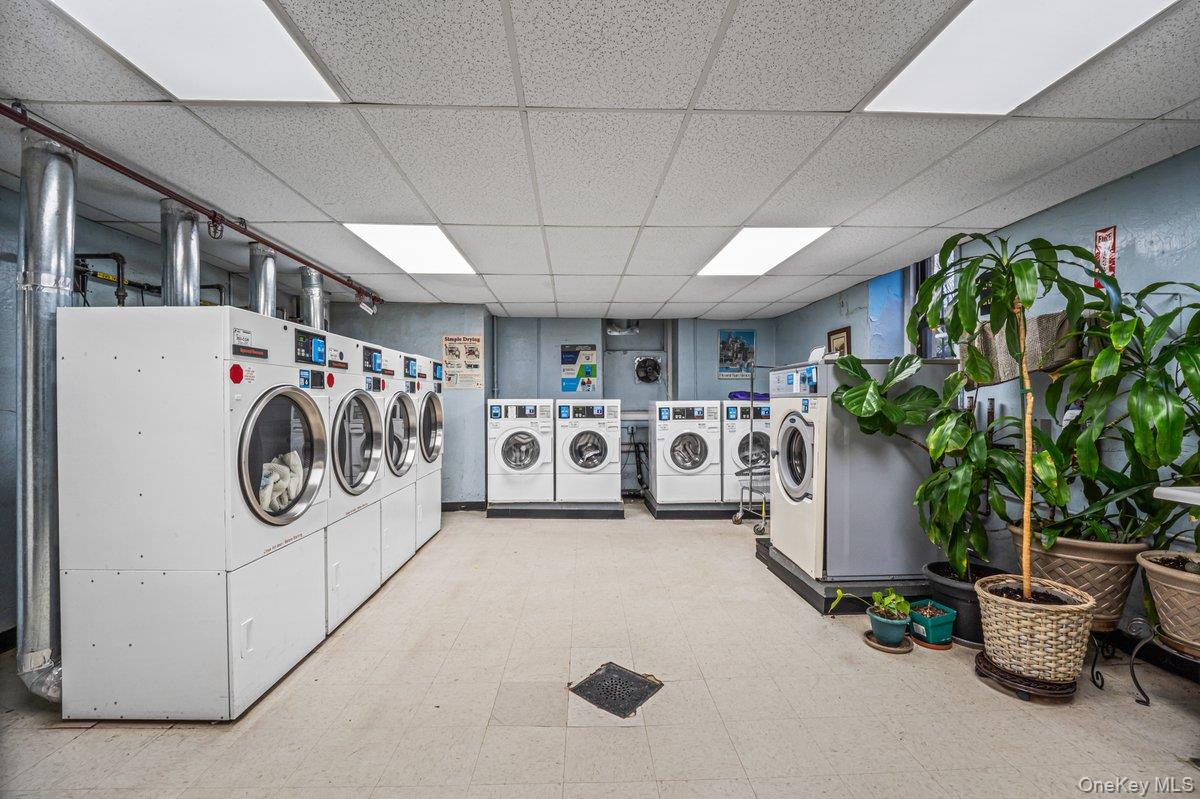 77-16 Austin Street, Unit 5L Queens, NY 11375 - Photo 9 of 13 a utility room with multiple dryer and washer