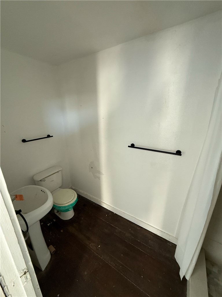 507 Logan Street Calvert, TX 77837 - Photo 13 of 19 Bathroom featuring dark wood finished floors and toilet