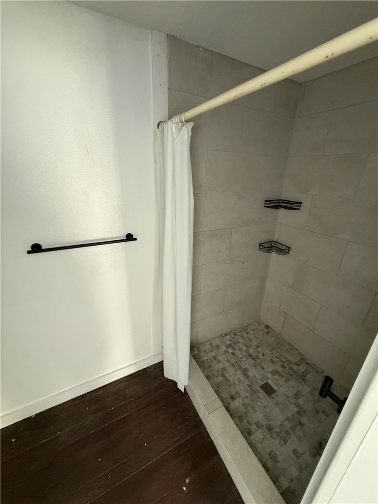 507 Logan Street Calvert, TX 77837 - Photo 14 of 19 Bathroom featuring wood-type flooring and a stall shower