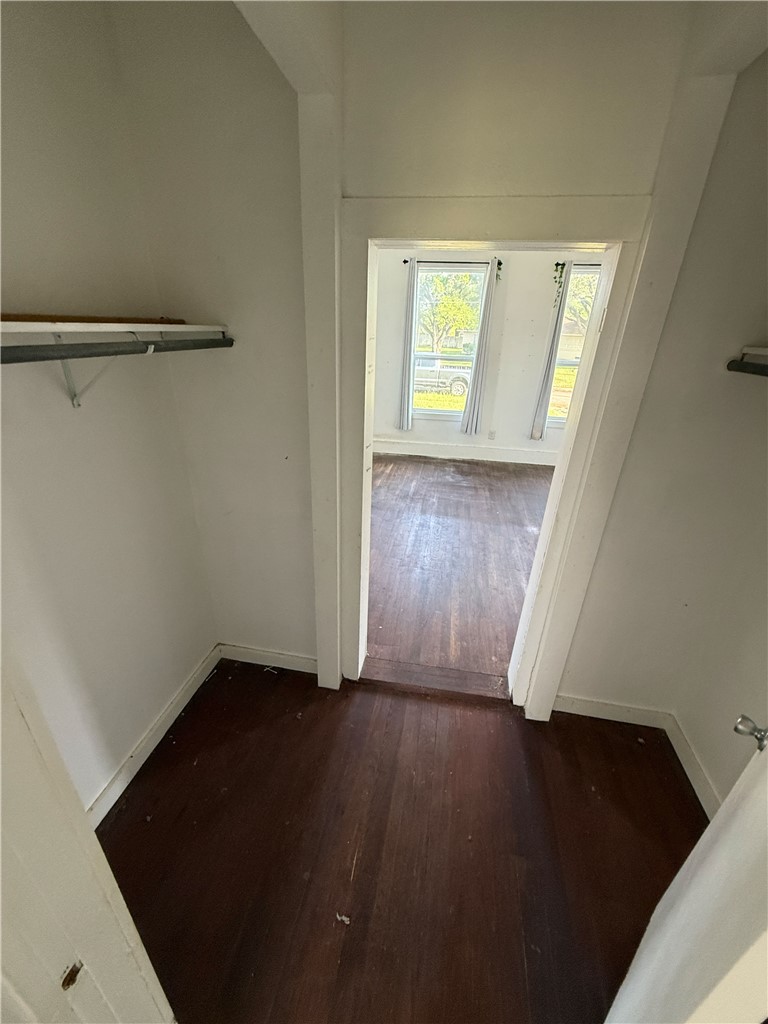 507 Logan Street Calvert, TX 77837 - Photo 5 of 19 Hallway with dark wood-style floors and baseboards