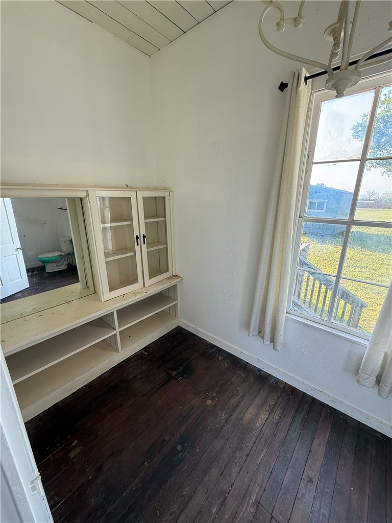 507 Logan Street Calvert, TX 77837 - Photo 6 of 19 Unfurnished dining area with dark wood-style flooring and a vaulted wood ceiling