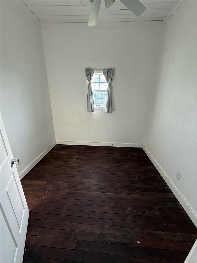 507 Logan Street Calvert, TX 77837 - Photo 10 of 19 Unfurnished room with dark wood-type flooring, wooden ceiling, and ceiling fan