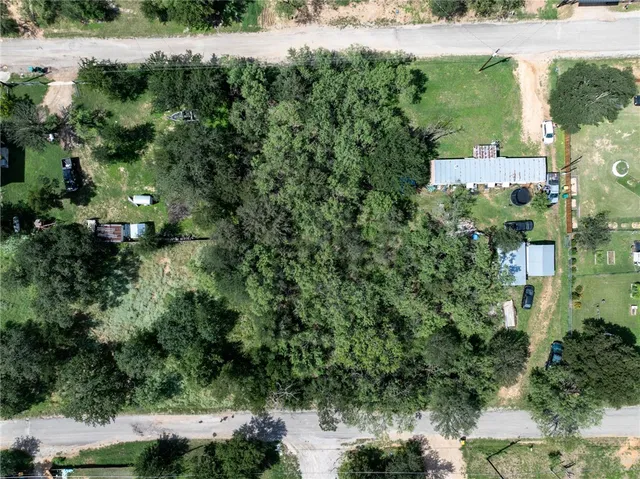 an aerial view of a house with a yard