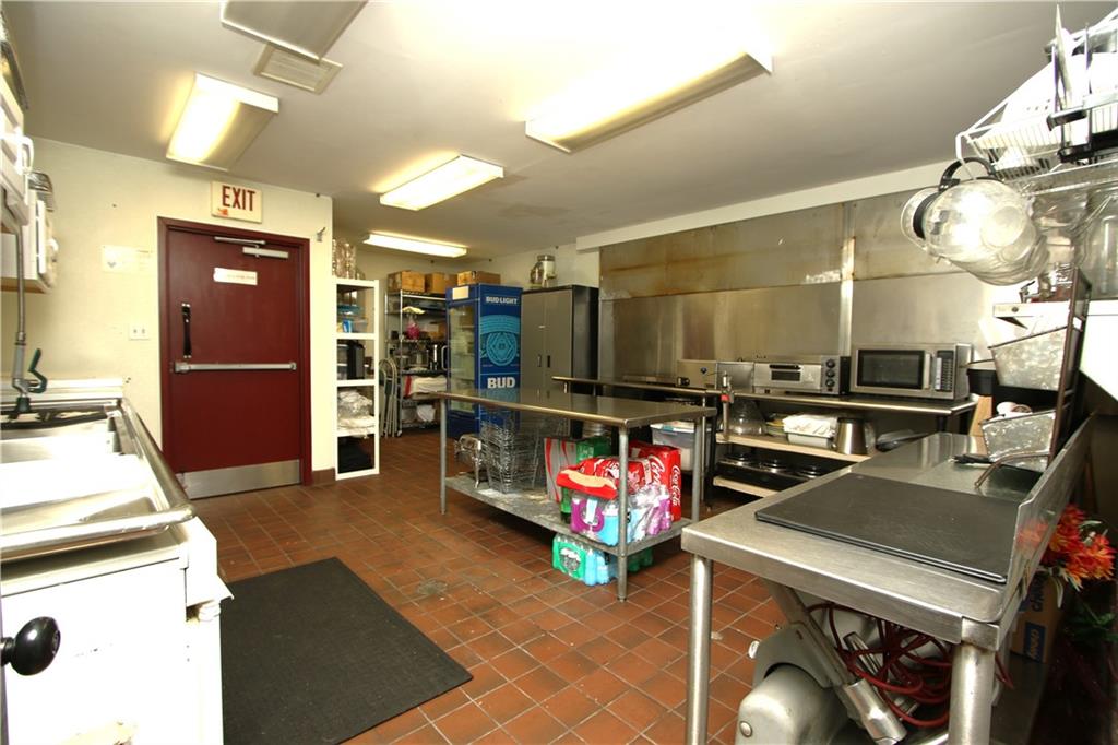 807 Dry Run Road Monongahela, PA 15063 - Photo 9 of 50 HUGE 15x15 Kitchen area w/ Ceramic Tile Floors, Stainless Steel Backing (Hood from previous business still in wall and can be reconnected if full kitchen is needed), multiple Stainless Steel prep tables