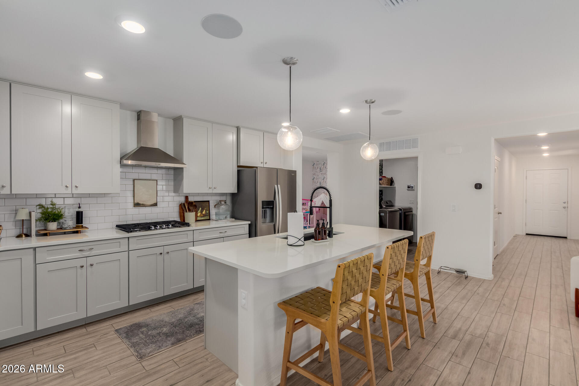4702 South Riata Street Gilbert, AZ 85297 - Photo 11 of 31 a kitchen with stainless steel appliances kitchen island granite countertop a sink a stove a dining table and chairs