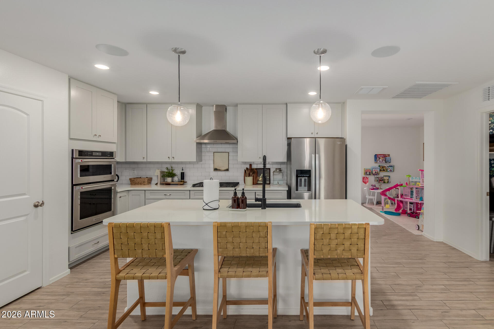 4702 South Riata Street Gilbert, AZ 85297 - Photo 12 of 31 a kitchen with refrigerator a stove a dining table and chairs