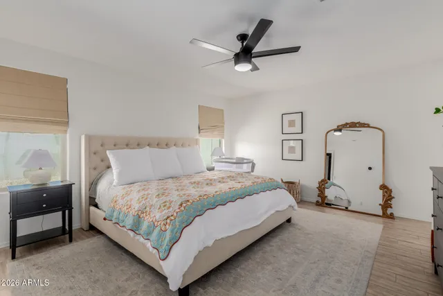 a bedroom with a bed and wooden floor