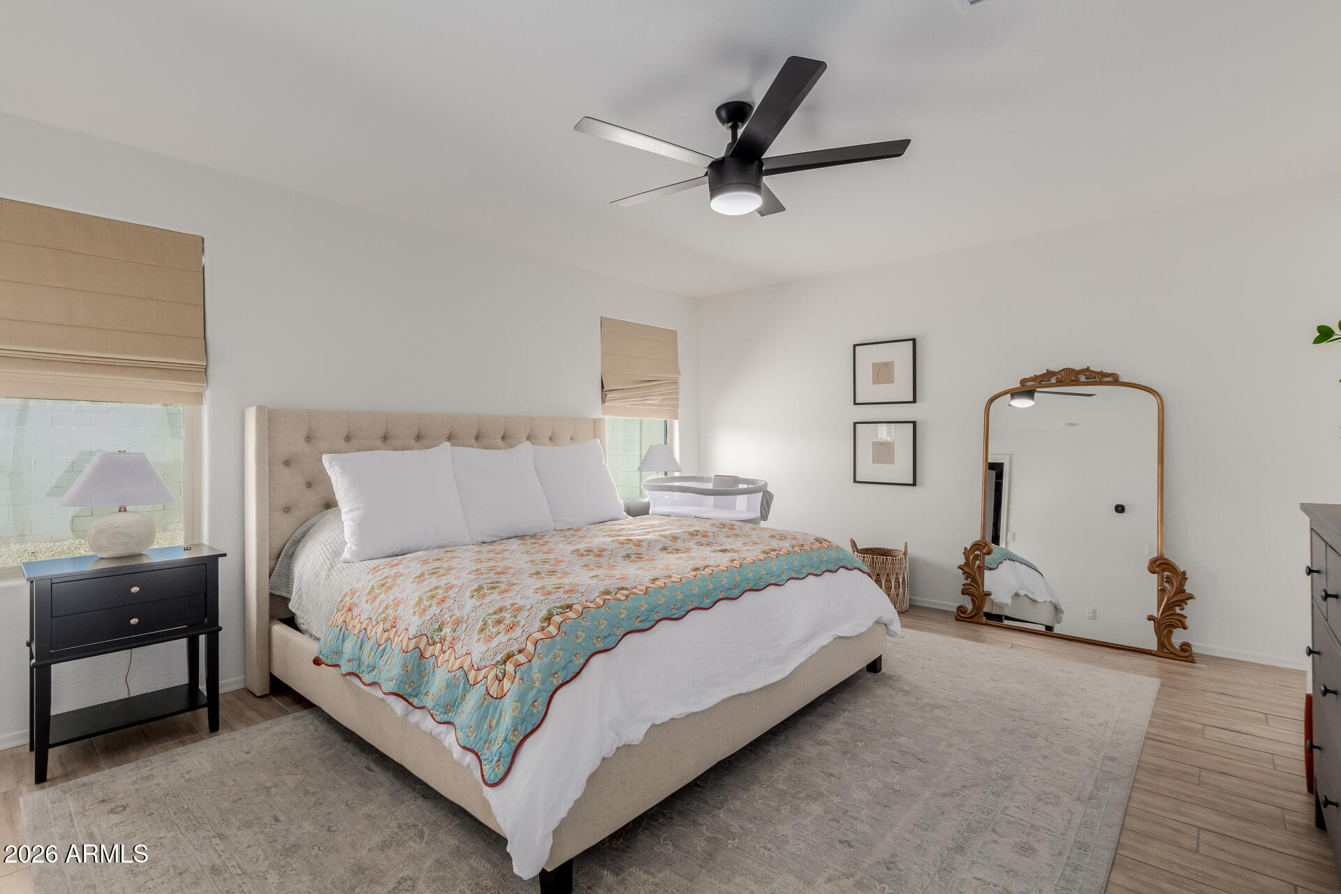 4702 South Riata Street Gilbert, AZ 85297 - Photo 14 of 31 a bedroom with a bed and wooden floor