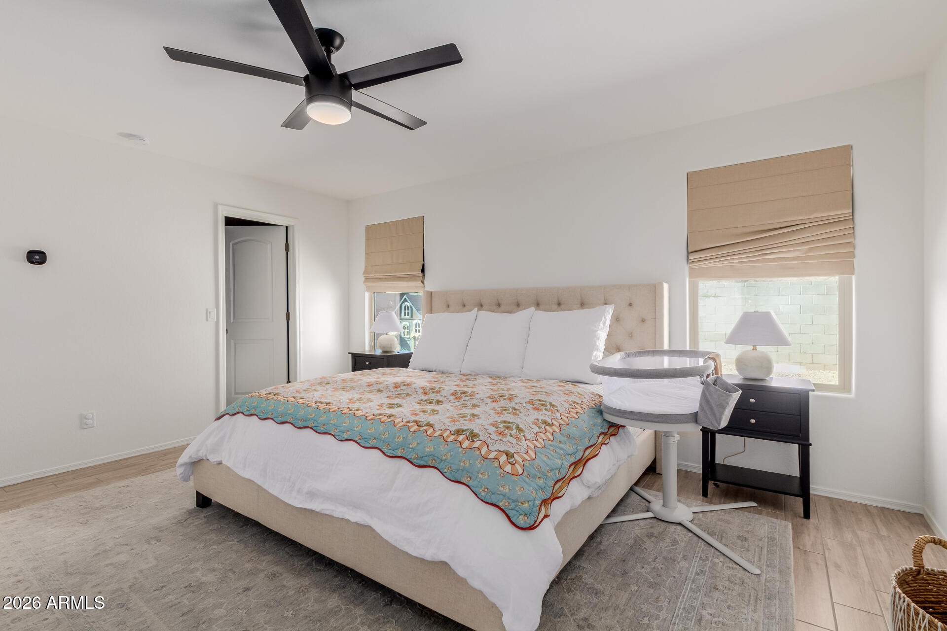 4702 South Riata Street Gilbert, AZ 85297 - Photo 16 of 31 a bedroom with a bed a chair and a potted plant