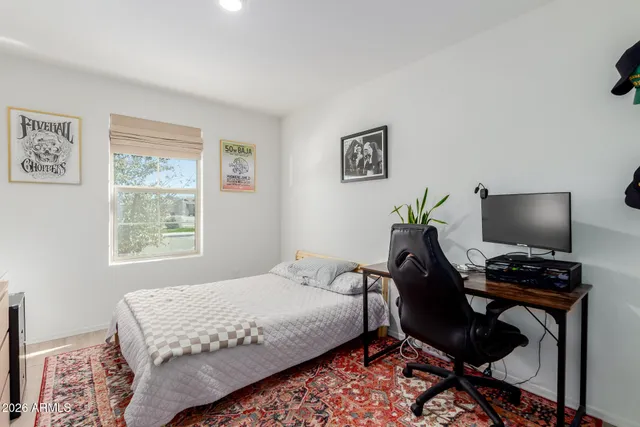 a bedroom with a workspace