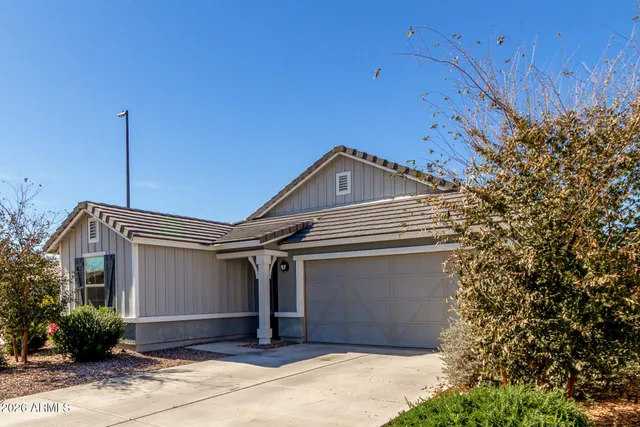 a front view of a house with a garden
