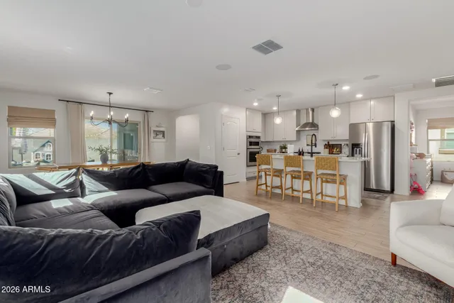 a living room with furniture and a view of kitchen
