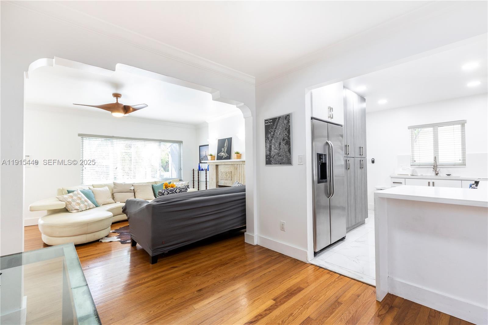 753 Northeast 81st Street Miami, FL 33138 - Photo 14 of 57 a living room with furniture and a kitchen
