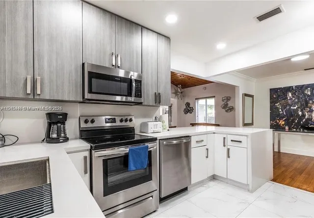 a kitchen with a sink stove and microwave