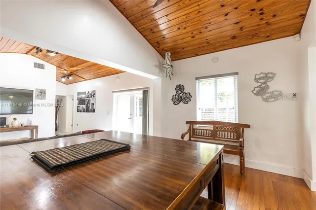 a living room with furniture rug and wooden floor