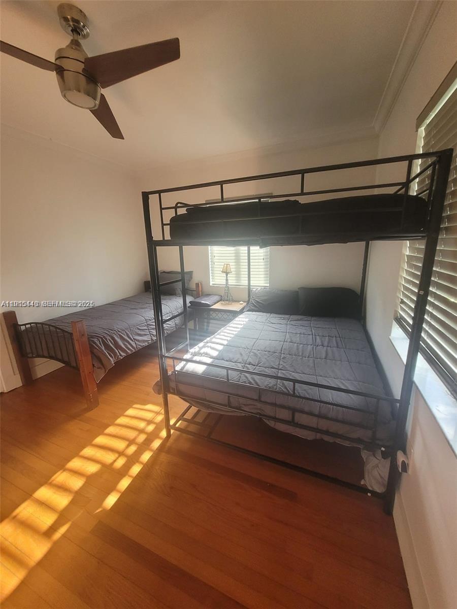 753 Northeast 81st Street Miami, FL 33138 - Photo 28 of 57 a bedroom with a bed and a chandelier