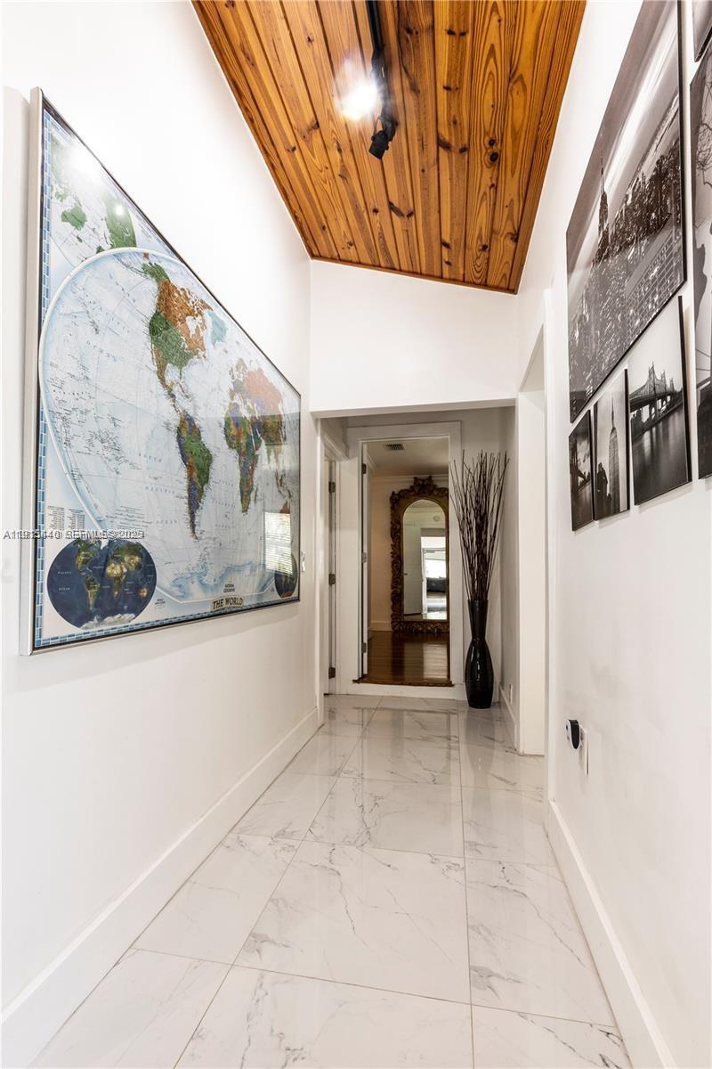 753 Northeast 81st Street Miami, FL 33138 - Photo 44 of 57 a view of a hallway with a white walls