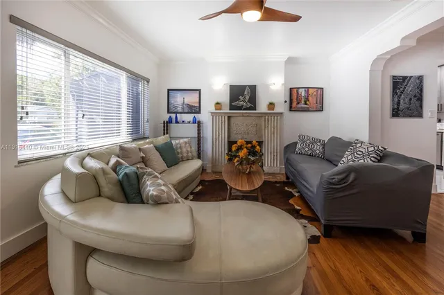 a living room with furniture and a wooden floor